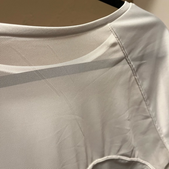 White workout top. Sheer panel on 1/4 of the back side. - Picture 2 of 3